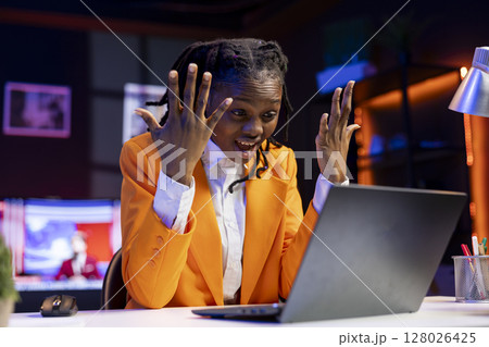 Angry freelancer at desk yelling while working from home in apartment office, upset by error on laptop screen. Stressed woman raging, having burnout while doing tasks on notebook Angry freelancer at desk yelling while working from home in apartment office, upset by error on laptop screen. Stressed woman raging, having burnout while doing tasks on notebook 128026425