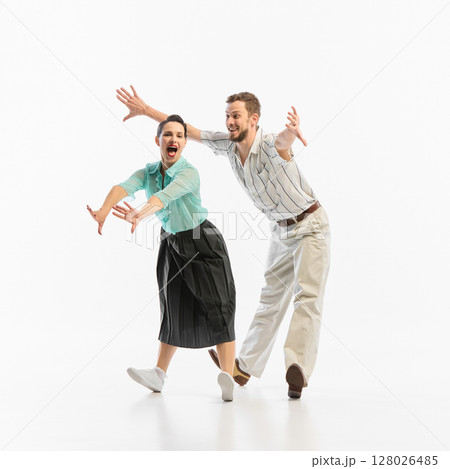 Vintage dance couple joyfully performing energetic routine together 128026485