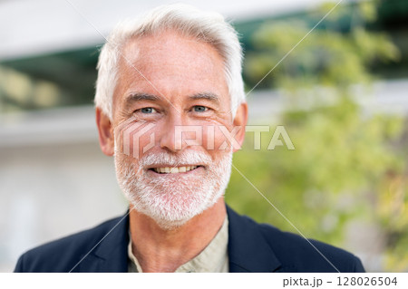 Smiling senior businessman looking at camera 128026504