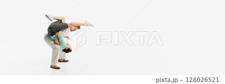 Energetic dancers performing acrobatic retro dance move against plain white background. Banner Energetic dancers performing acrobatic retro dance move against plain white background. Banner 128026521