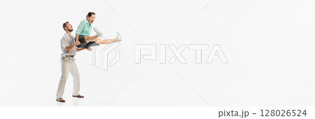 Retro dance couple performing energetic lift against white background. Banner Retro dance couple performing energetic lift against white background. Banner 128026524