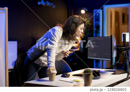 System administrator with disposable cup of coffee entering office to implement security measures, protecting company systems and data. IT expert starting job shift with hot beverage, testing code System administrator with disposable cup of coffee entering office to implement security measures, protecting company systems and data. IT expert starting job shift with hot beverage, testing code 128026601