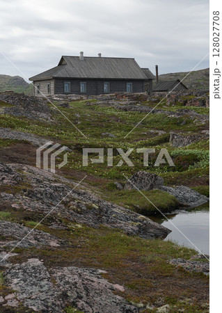 Solitary Abandoned House on a Rocky Hill Under Cloudy Sky in Teriberka, Russia 128027708