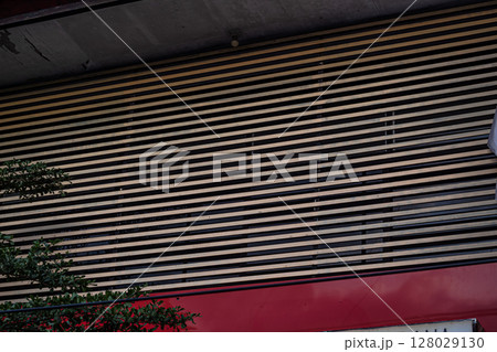 Modern Building Exterior Featuring Geometric Louvers and Red Element Modern Building Exterior Featuring Geometric Louvers and Red Element 128029130