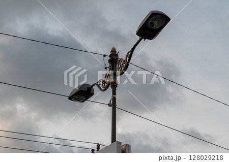 Decorative vintage street lamp with double lights against a cloudy sky. Decorative vintage street lamp with double lights against a cloudy sky. 128029218