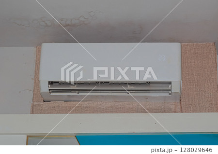 Water stain and dampness on residential ceiling from malfunctioning AC unit Water stain and dampness on residential ceiling from malfunctioning AC unit 128029646