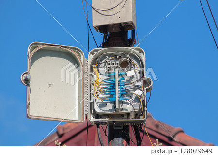 Open Fiber Optic Box Showing Cable Connections on Utility Pole Open Fiber Optic Box Showing Cable Connections on Utility Pole 128029649