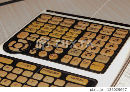 Close-up view of vintage electronic device control panel with many buttons 128029667