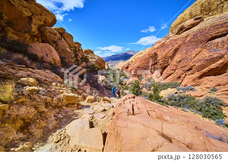 Hikers Traverse Red Rock Canyon Sandstone Cliffs Aerial Hikers Traverse Red Rock Canyon Sandstone Cliffs Aerial 128030565