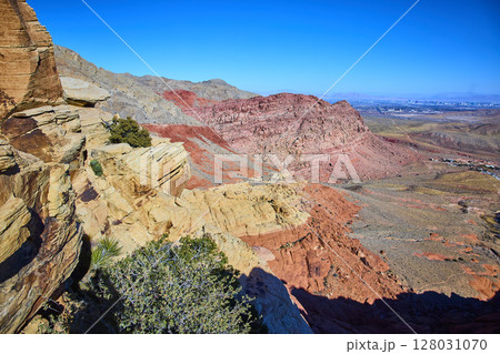 Red Rock Canyon Desert Landscape with Las Vegas Skyline in Background 128031070