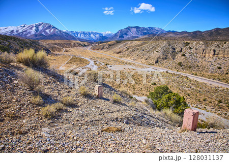 Desert Landscape with Snowy Mountains and Roadway Eye-Level View 128031137