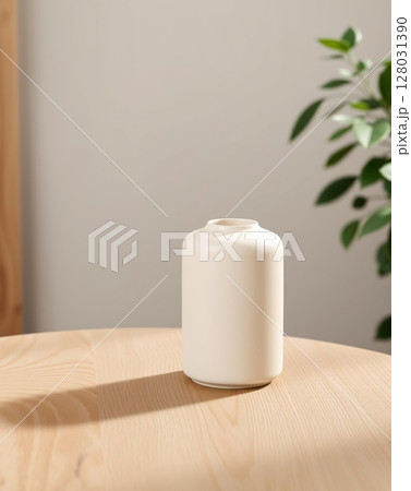 A minimalistic off-white vase on a wooden table with a shadow cast by sunlight. 128031390