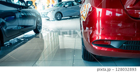 Car parked in luxury showroom. Car dealership office. Car showroom business. New car parked in modern showroom. Auto for sale and rent business. Automobile leasing and insurance. Electric automobile. 128032893