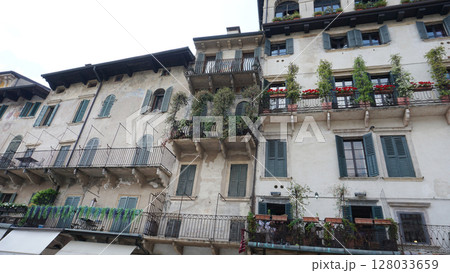 Beautiful traditional Italian building with flowers on balcony of medieval wall, Verona, Italy 128033659