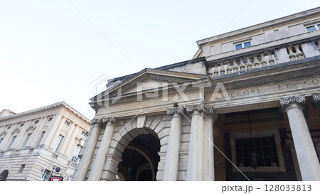 Verona, Italy Latin inscription on the portal of Piazza Bra, built in 1929 during the Fascist Era. Neoclassical facade with Ionic columns in central Verona, Veneto. 128033813