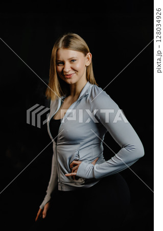 Confident sportswoman posing in a gym 128034926