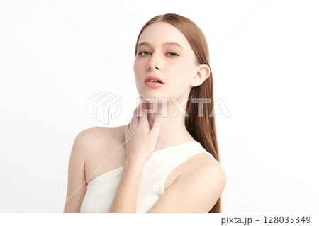 A beautiful young woman with clean, fresh skin against a white background. Skincare, facial treatment, cosmetology, beauty, and spa. An elegant portrait of an woman. 128035349