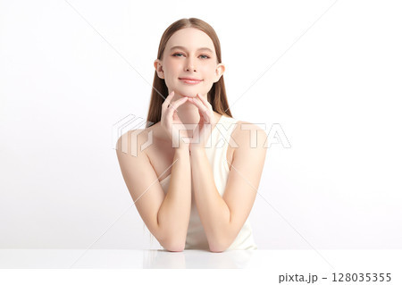 A beautiful young woman with clean, fresh skin against a white background. Skincare, facial treatment, cosmetology, beauty, and spa. An elegant portrait of an woman. A beautiful young woman with clean, fresh skin against a white background. Skincare, facial treatment, cosmetology, beauty, and spa. An elegant portrait of an woman. 128035355