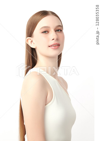 A beautiful young woman with clean, fresh skin against a white background. Skincare, facial treatment, cosmetology, beauty, and spa. An elegant portrait of an woman. A beautiful young woman with clean, fresh skin against a white background. Skincare, facial treatment, cosmetology, beauty, and spa. An elegant portrait of an woman. 128035358