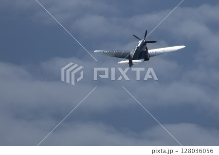 Spitfire plane in flight on sunny day. High quality photo 128036056