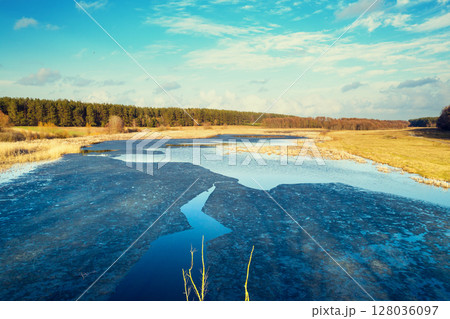 Aerial view of countryside and frozen stream on a sunny spring day. Beautiful natural landscape 128036097