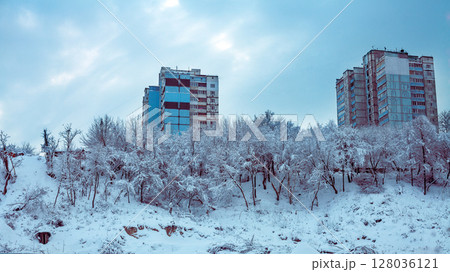 Cityscape in winter after snowfall. Winter cityscape with cloudy sky 128036121