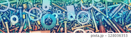 Abstract grunge colorful metal background made of fastening bolts, screws, and nuts. Horizontal banner 128036353