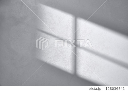Concrete texture background with shadows from natural light streaming through a window. 128036841
