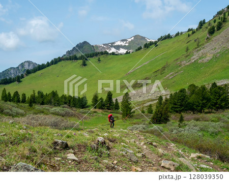 Difficult hill climb with a heavy backpack. Difficult hill climb with a heavy backpack. 128039350