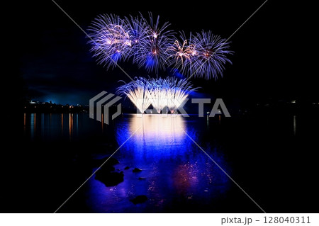 Beautiful colorful fireworks with reflections in water. Brno dam, the city of Brno-Europe. International Fireworks Competition. 128040311
