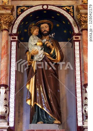 Saint Joseph holding baby Jesus, statue on the altar of Saint Joseph in the Church of Saint Barbara in Rude, Croatia Saint Joseph holding baby Jesus, statue on the altar of Saint Joseph in the Church of Saint Barbara in Rude, Croatia 128042179