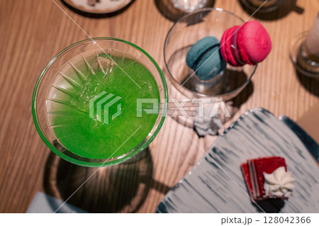 Green cocktail on a wooden table Green cocktail on a wooden table 128042366