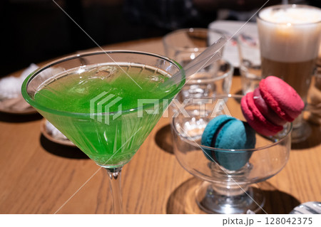 Green cocktail on a wooden table Green cocktail on a wooden table 128042375