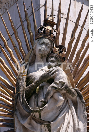 Virgin Mary with baby Jesus, statue on the corner of the facade of the San Michele in Foro Church in Lucca, Italy Virgin Mary with baby Jesus, statue on the corner of the facade of the San Michele in Foro Church in Lucca, Italy 128043452
