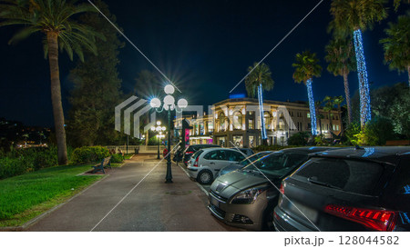 Night view to street with palms on the center of Beaulieu-sur-Mer timelapse hyperlapse. 128044582