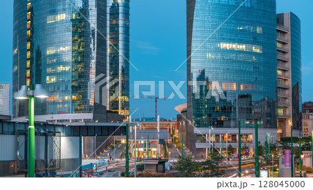 Milan skyline with modern skyscrapers in Porta Nuova business district day to night timelapse in Milan, Italy, after sunset. Milan skyline with modern skyscrapers in Porta Nuova business district day to night timelapse in Milan, Italy, after sunset. 128045000