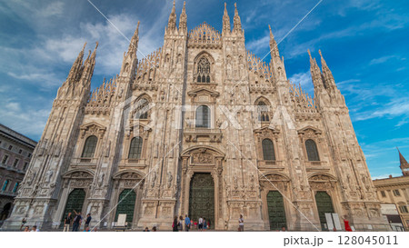 The Duomo cathedral timelapse hyperlapse at sunset. Front view with people sitting on stairs The Duomo cathedral timelapse hyperlapse at sunset. Front view with people sitting on stairs 128045011