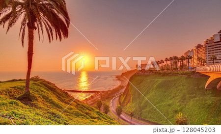 Aerial sunset view of Lima's Coastline in the neighborhood of Miraflores timelapse, Lima, Peru 128045203