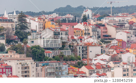 Colorful houses and residential buildings timelapse near Barrio Alto district Lisbon, capital city of Portugal. 128045259
