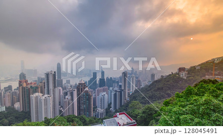 The famous view of Hong Kong from Victoria Peak timelapse. Taken at sunrise while the sun climbs over Kowloon Bay. 128045491
