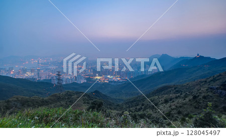 Cityscape of Hong Kong as viewed atop Kowloon Peak with day to night timelapse with Kowloon below Cityscape of Hong Kong as viewed atop Kowloon Peak with day to night timelapse with Kowloon below 128045497