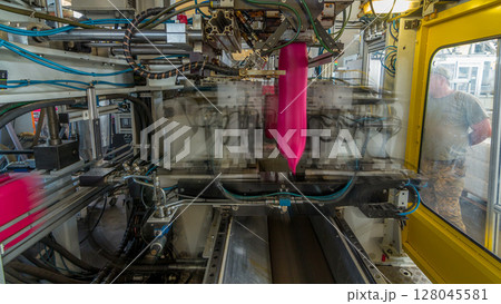 A factory for plastic canister production timelapse hyperlapse. The conveyor in the factory. 128045581