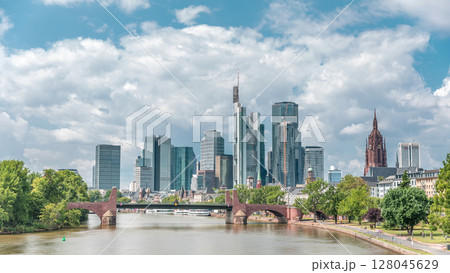Hyperlapse of Frankfurt's skyscrapers skyline with the bell tower overlooking Alte Brucke. Frankfurt, Germany Hyperlapse of Frankfurt's skyscrapers skyline with the bell tower overlooking Alte Brucke. Frankfurt, Germany 128045629