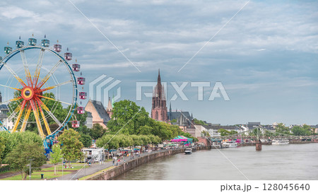 Aerial hyperlapse of pleasure boats on the Rhine Main, framed by the spire of Kaiserdom St. Bartholomaus. Germany 128045640