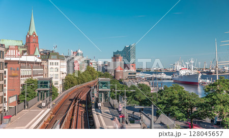 Aerial hyperlapse of trains arriving at Landungsbrucken station in Hamburg, Germany 128045657
