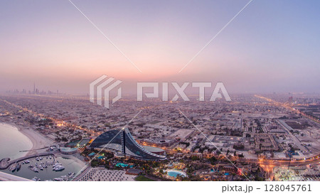 Skyline view of Dubai from night to day transition, UAE. Timelapse Skyline view of Dubai from night to day transition, UAE. Timelapse 128045761