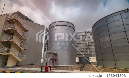 Two silver Water Tanks with fence timelapse hyperlapse Two silver Water Tanks with fence timelapse hyperlapse 128045808