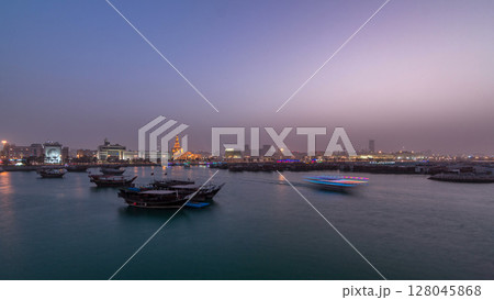 Evening at Doha Bay day to night timelapse with Traditional Wooden Dhow Fishing Boats. Evening at Doha Bay day to night timelapse with Traditional Wooden Dhow Fishing Boats. 128045868