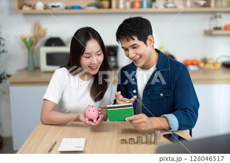 Couple Engaging in Financial Planning with Piggy Bank and Savings. Couple Engaging in Financial Planning with Piggy Bank and Savings. 128046517