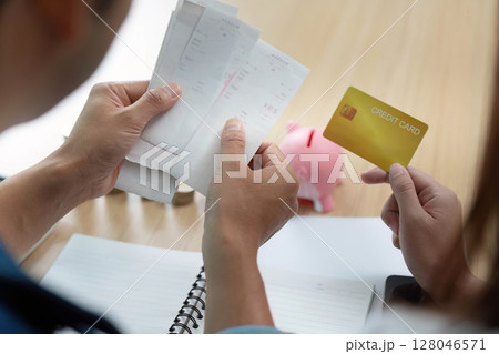 Expense Tracking and Financial Decisions. Couple analyzing receipts and credit card. 128046571